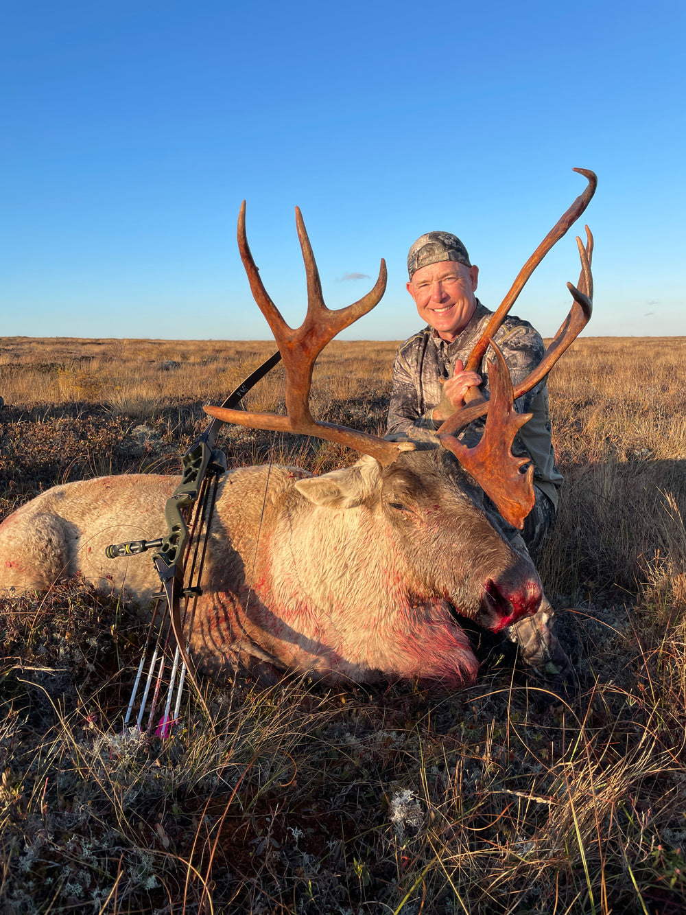 fred eichler with his fred eichler signature series riser take down bow and a caribou